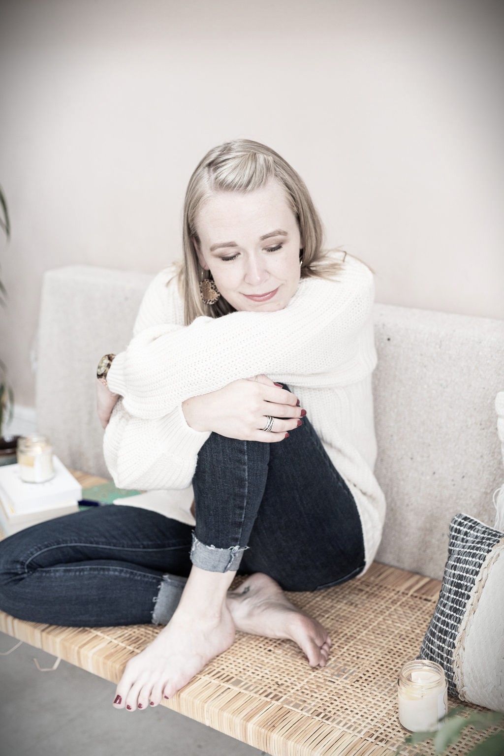 Lindsey Hall, Divorce and Intimacy Coach, sitting curled up on a bench with eyes closed—capturing the emotional vulnerability and exhaustion of early separation and post-divorce overwhelm.